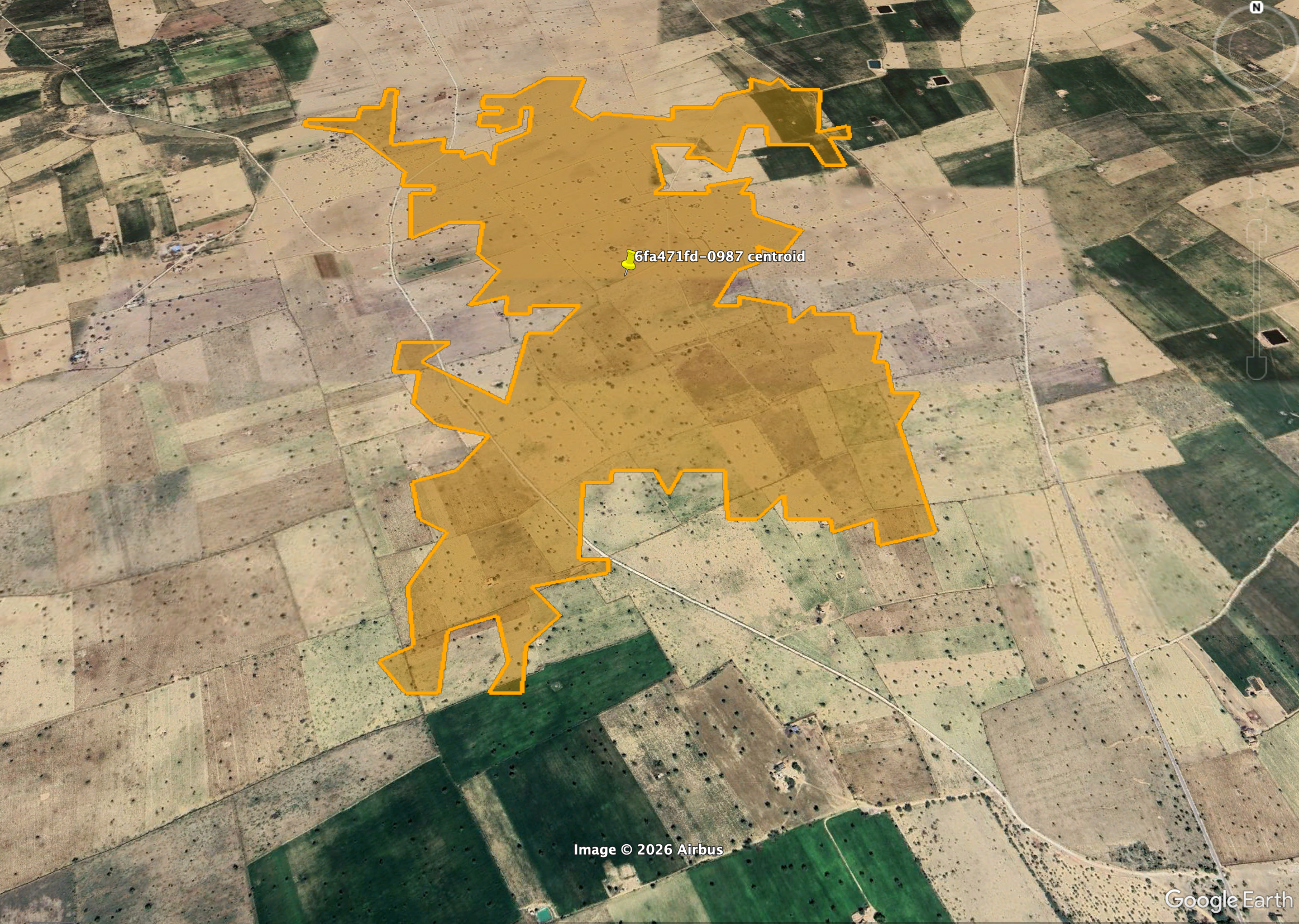 A sample site boundary drawn in Google Earth Pro — a closed blue polygon traced around the site over the satellite imagery, with exclusion areas drawn inside it.